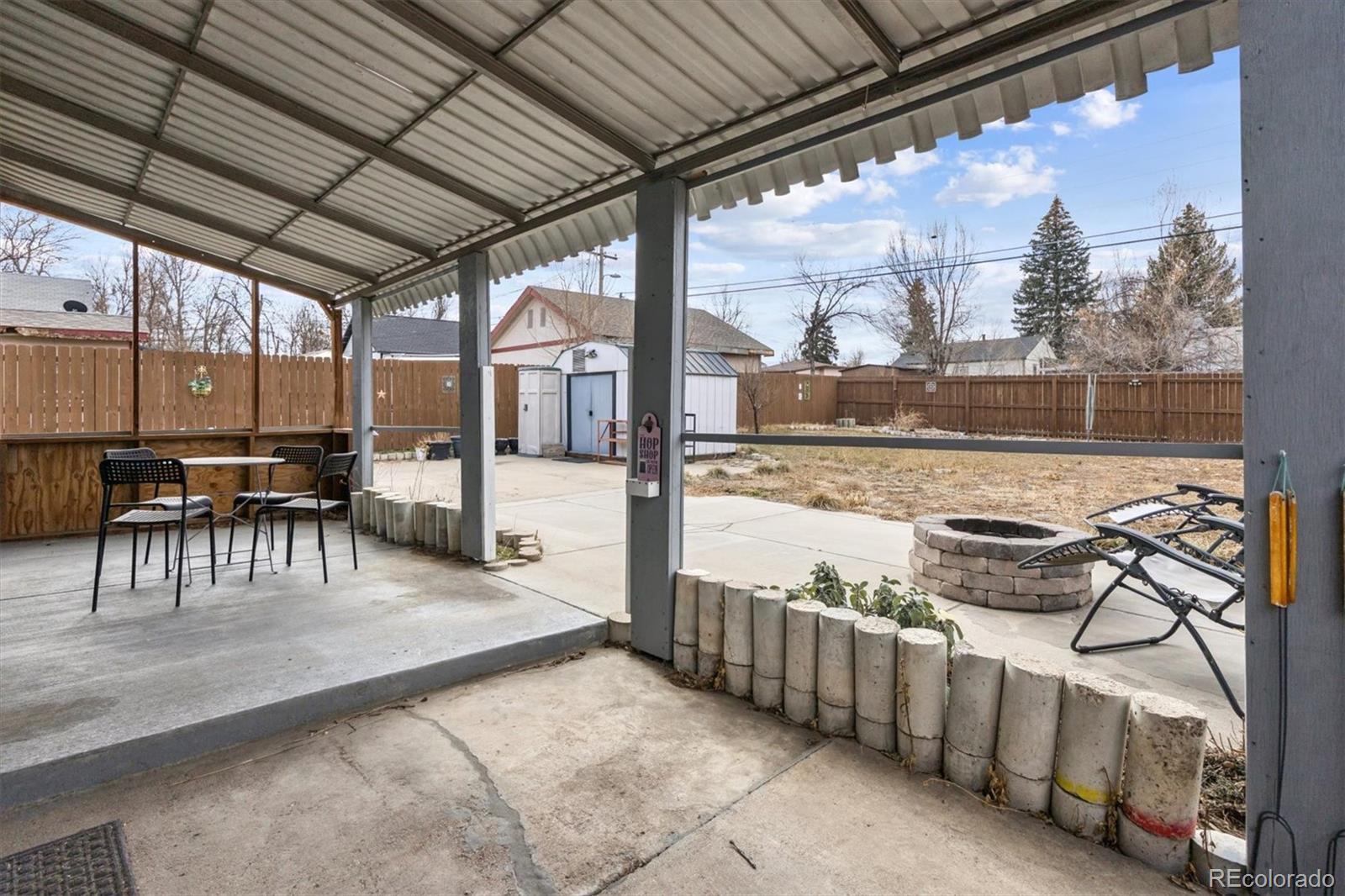 1275 Clinton Street Aurora, CO 80010 - Photo 26 of 33 a view of a porch with furniture and a yard