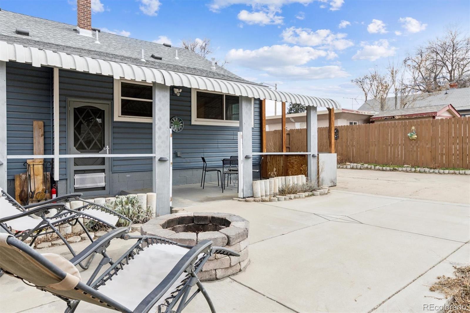 1275 Clinton Street Aurora, CO 80010 - Photo 28 of 33 a view of a patio with couches table and chairs