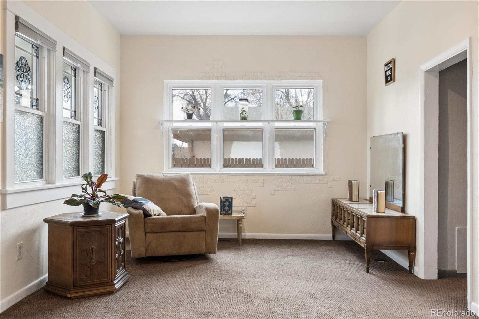 1275 Clinton Street Aurora, CO 80010 - Photo 3 of 33 a living room with furniture and a window