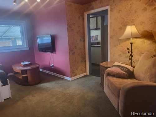 1275 Clinton Street Aurora, CO 80010 - Photo 32 of 33 a living room with furniture and a flat screen tv