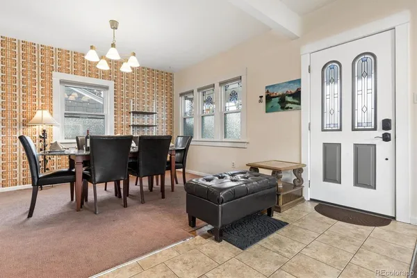 a living room with furniture and a chandelier