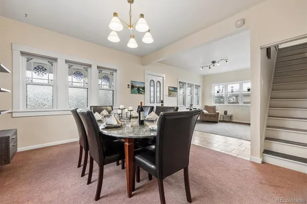 a view of a dining room with furniture and chandelier