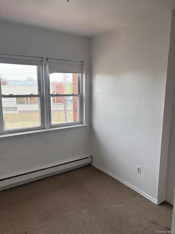 91-04 75th Street, Unit 2 Queens, NY 11421 - Photo 3 of 7 an empty room with a window
