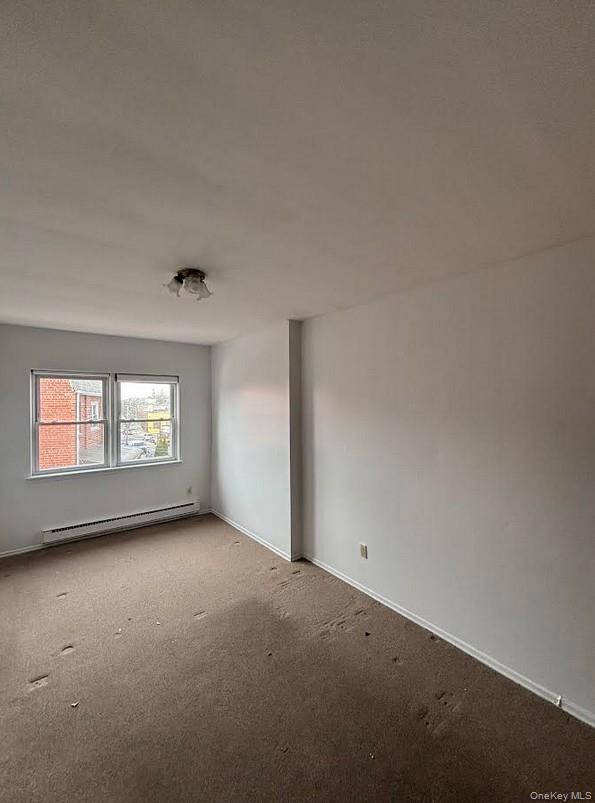 91-04 75th Street, Unit 2 Queens, NY 11421 - Photo 5 of 7 an empty room with windows