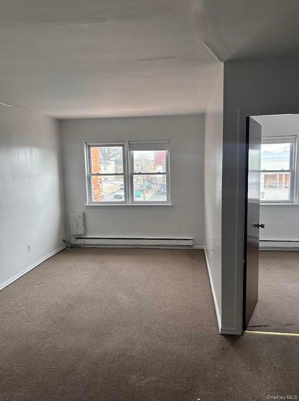 91-04 75th Street, Unit 2 Queens, NY 11421 - Photo 6 of 7 an empty room with a window