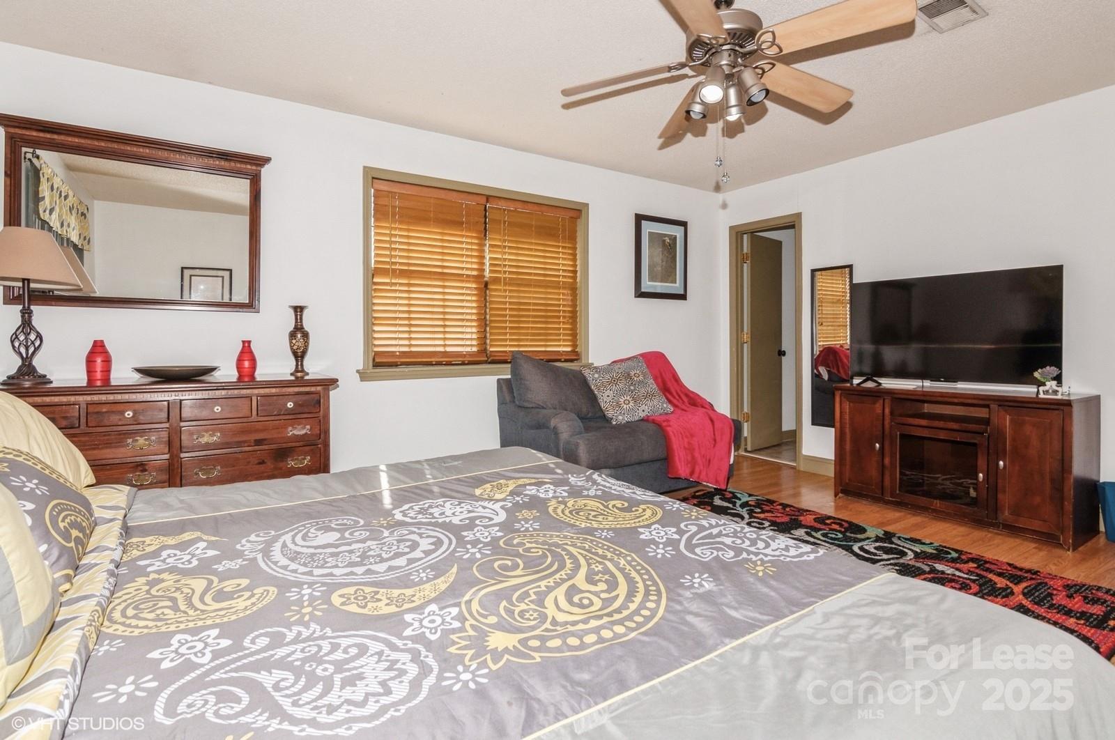 9938 Sandra Lane Fort Mill, SC 29707 - Photo 16 of 36 a bedroom with a bed and a flat screen tv