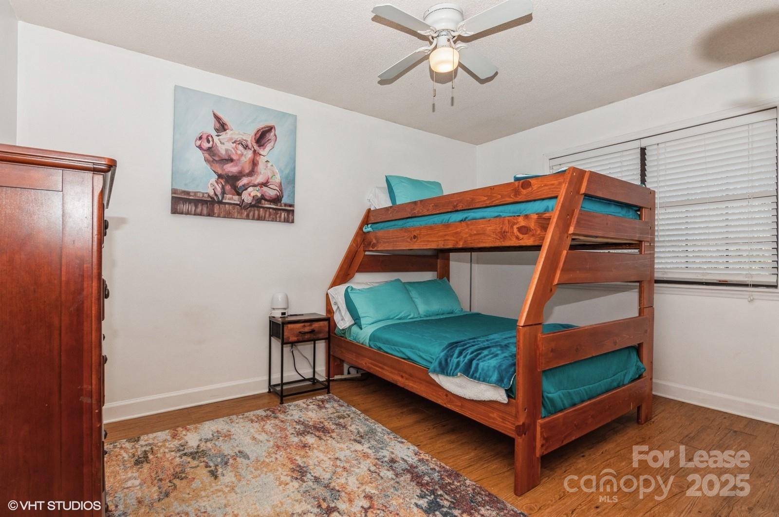 9938 Sandra Lane Fort Mill, SC 29707 - Photo 21 of 36 a bedroom with a bed and a chandelier