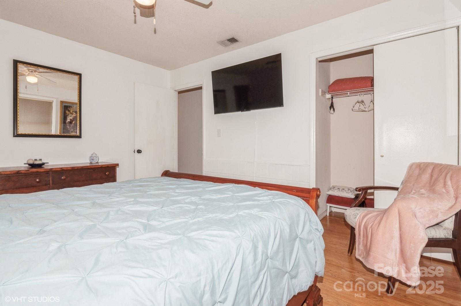 9938 Sandra Lane Fort Mill, SC 29707 - Photo 26 of 36 a bedroom with a bed and a flat screen tv