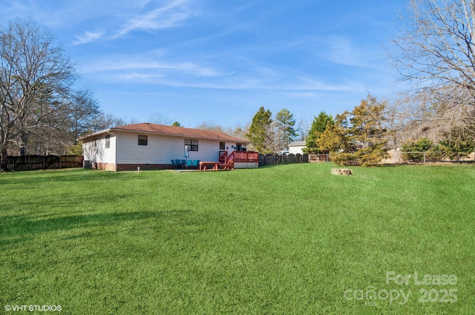 9938 Sandra Lane Fort Mill, SC 29707 - Photo 33 of 36 a city view with tall trees and a big yard