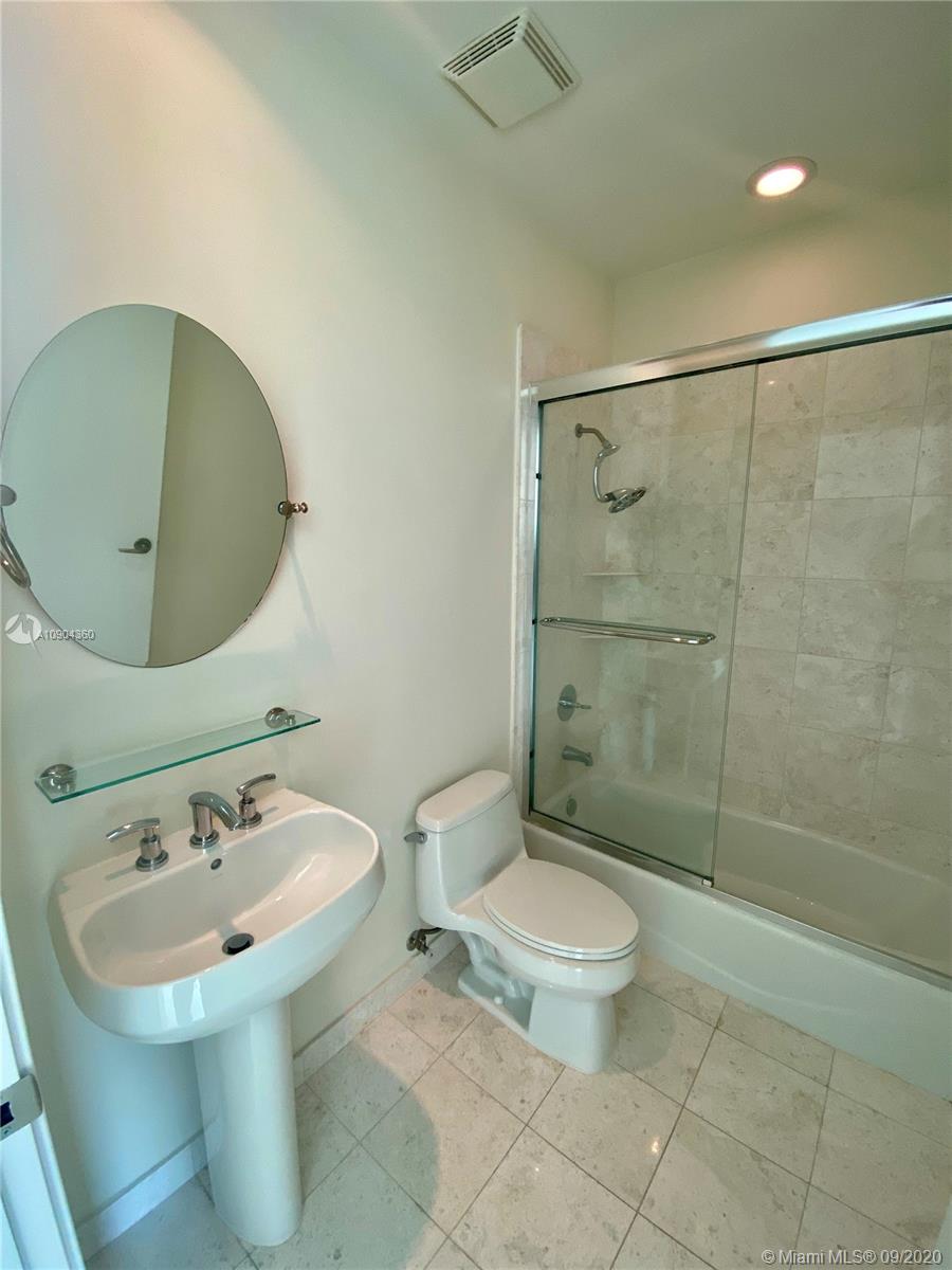 900 Brickell Key Boulevard, Unit 2001 Miami, FL 33131 - Photo 13 of 22 a bathroom with a sink toilet and shower