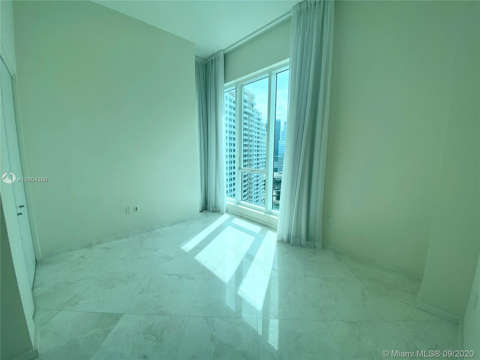 900 Brickell Key Boulevard, Unit 2001 Miami, FL 33131 - Photo 14 of 22 a view of an empty room with a window