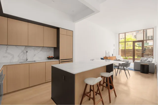 a kitchen with a table chairs stove and cabinets