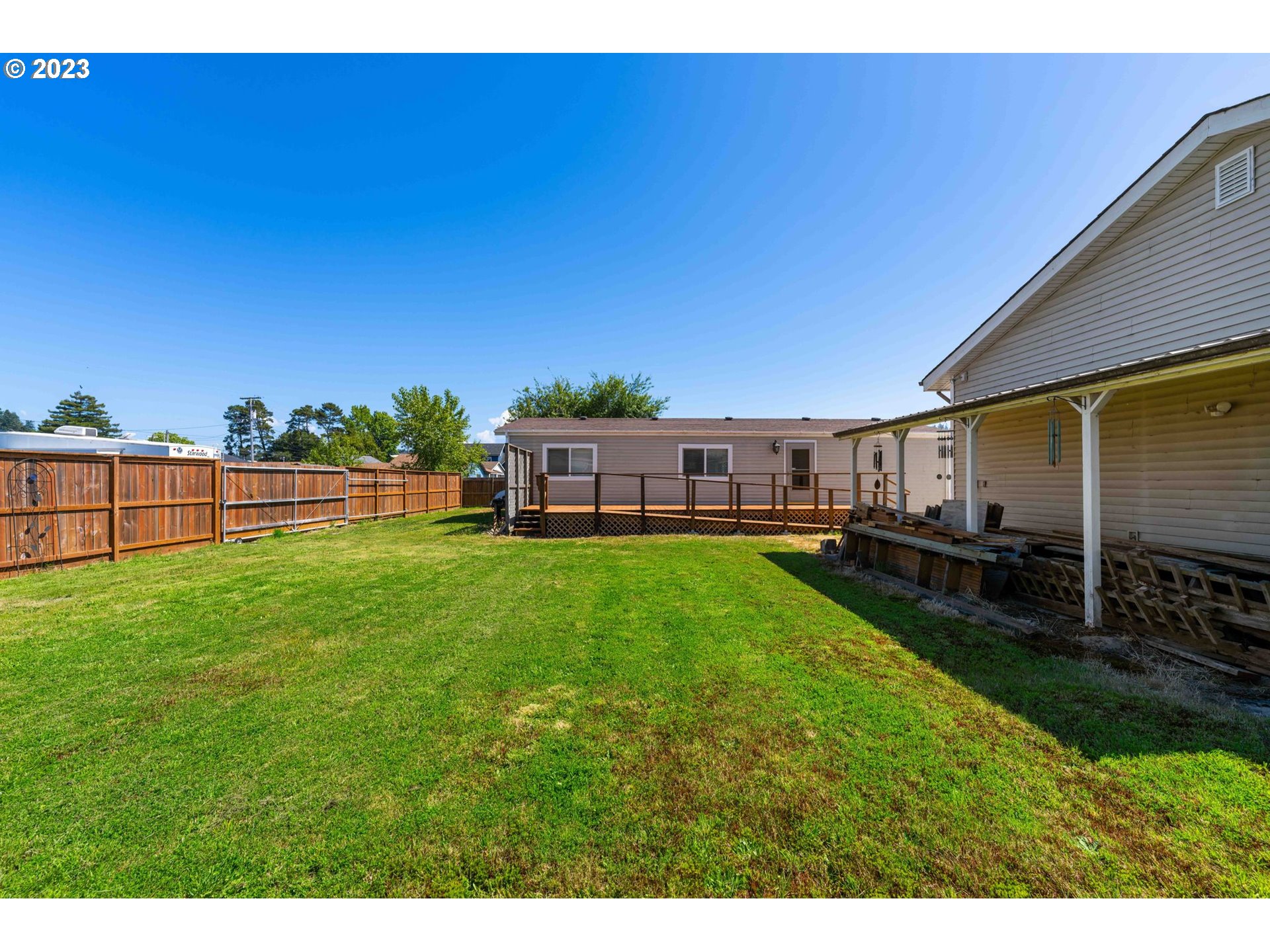 150 North 11th Street Lakeside, OR 97449 - Photo 4 of 24 a view of a yard with a house in the background