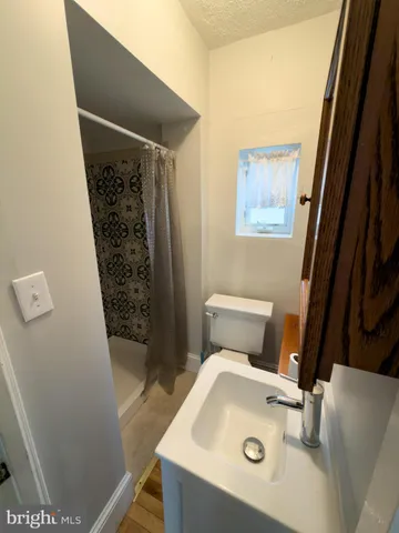 a bathroom with a sink and glass door