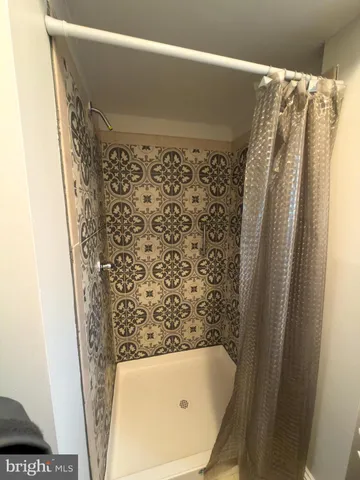 a bathroom with a bathtub and shower