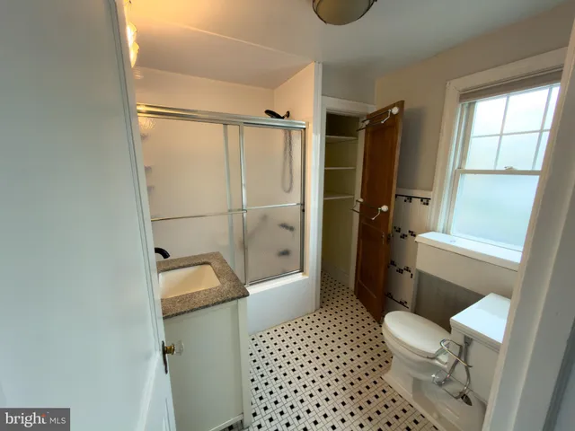 a bathroom with a toilet a sink and shower