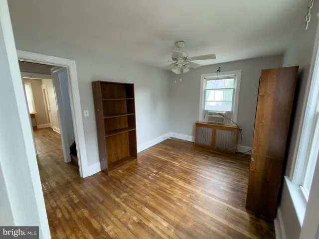 wooden floor in an empty room with a bathroom