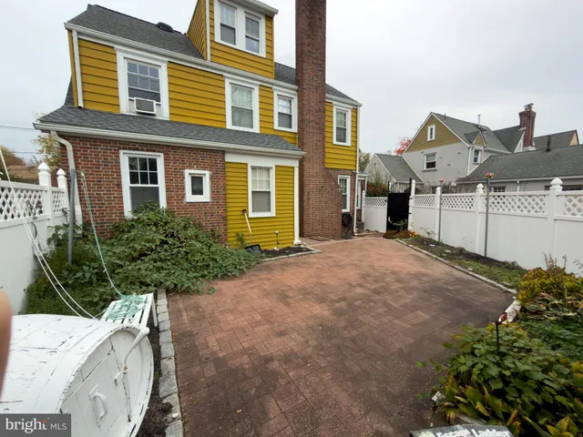 a view of a house with a yard and potted plants