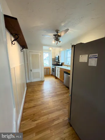 a view of a kitchen from a hallway