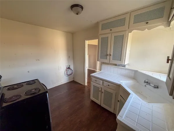 a kitchen with a stove and a refrigerator