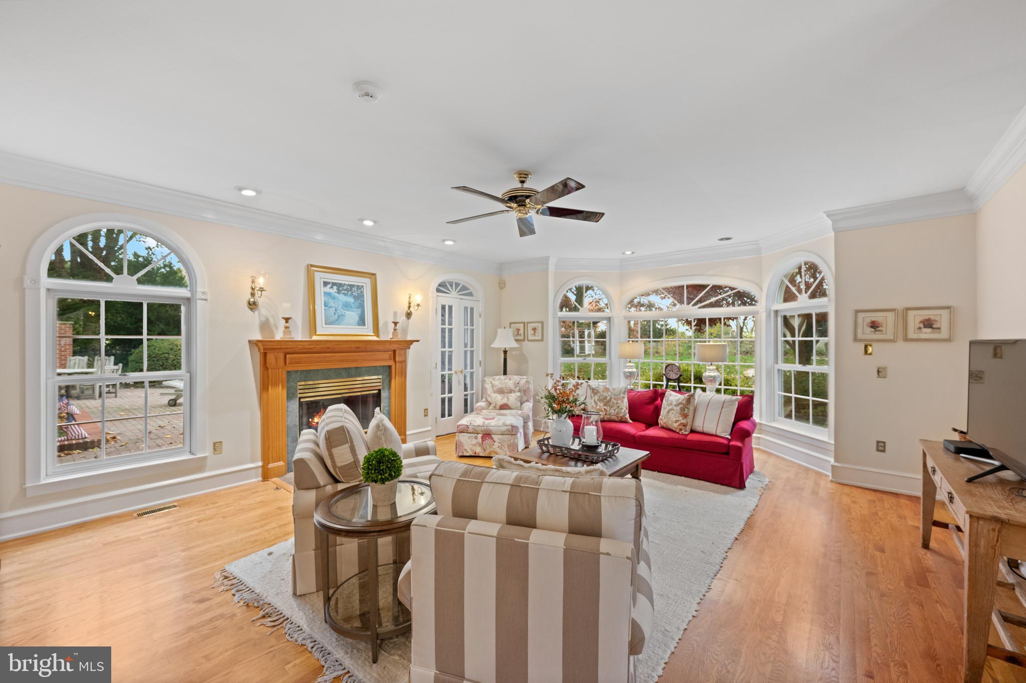 328 Conestoga Road Wayne, PA 19087 - Photo 23 of 72 a living room with furniture a fireplace and a floor to ceiling window