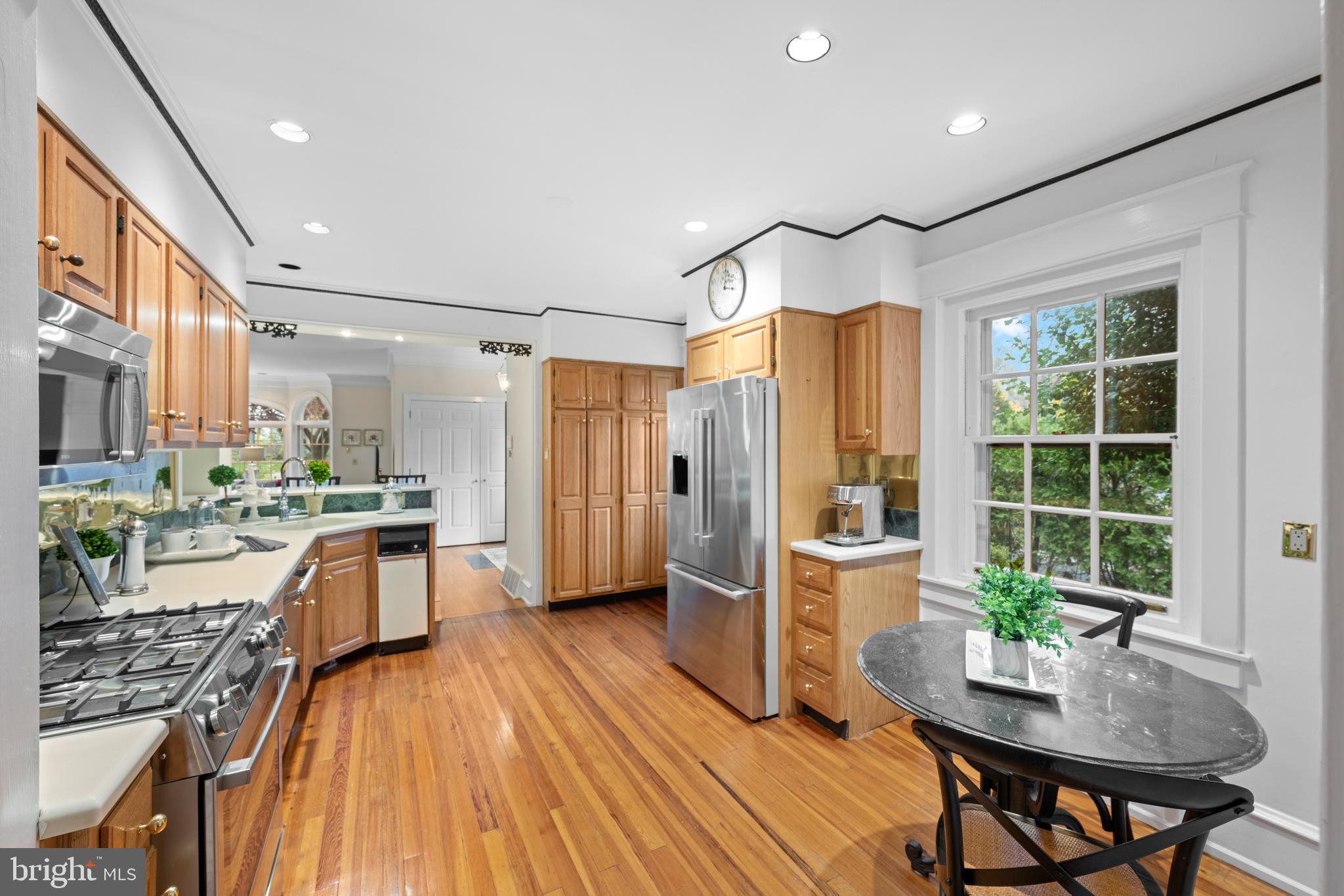 328 Conestoga Road Wayne, PA 19087 - Photo 30 of 72 a kitchen with stainless steel appliances a stove a refrigerator a sink a dining table and chairs with wooden floor