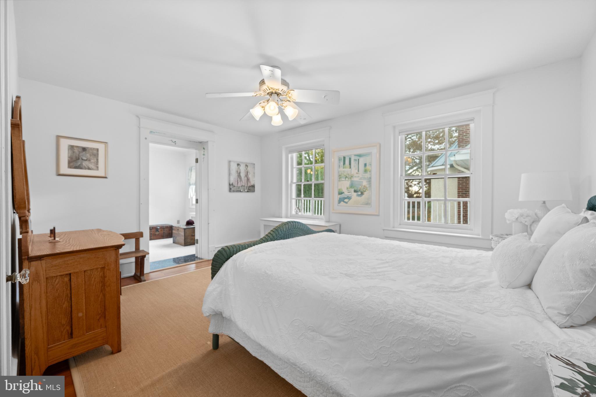328 Conestoga Road Wayne, PA 19087 - Photo 53 of 72 a spacious bedroom with a large bed and a chandelier