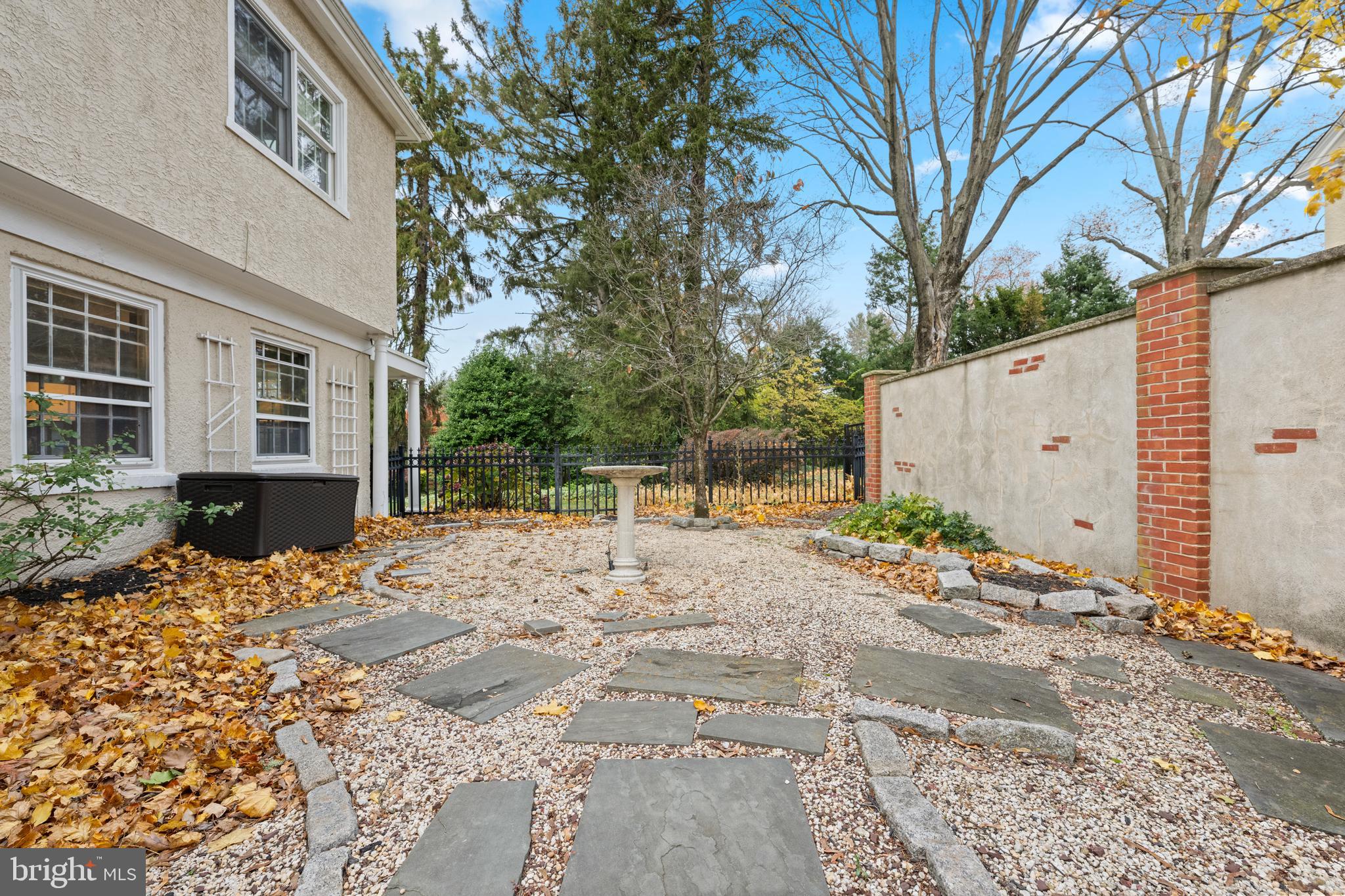 328 Conestoga Road Wayne, PA 19087 - Photo 62 of 72 a backyard of a house with potted plants and large trees
