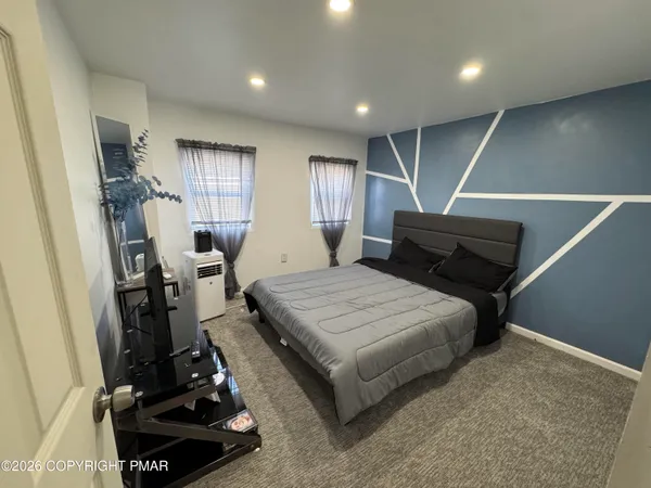 a bedroom with furniture and a window