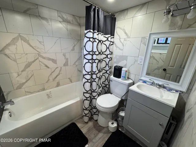 a bathroom with a sink toilet and shower