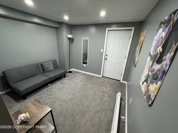 a living room with furniture and a rug