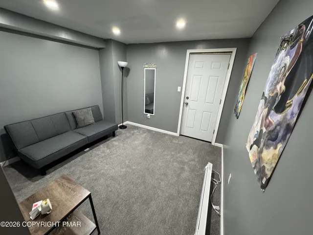 a living room with furniture and a rug