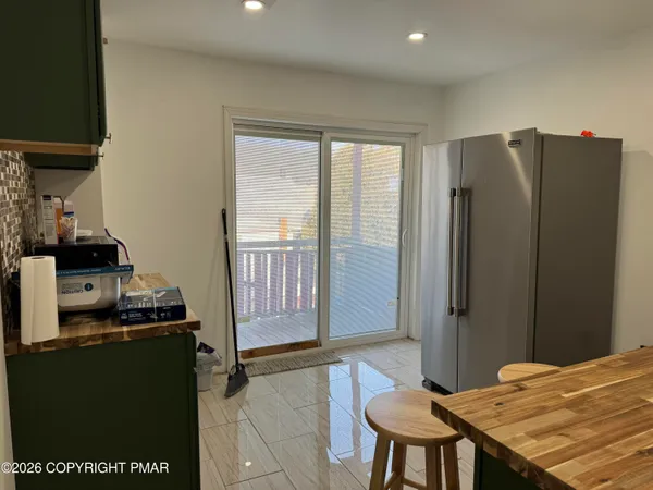 a kitchen with a refrigerator and a stove top oven