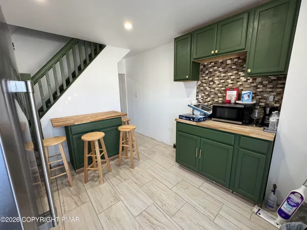 a kitchen with furniture and a fireplace
