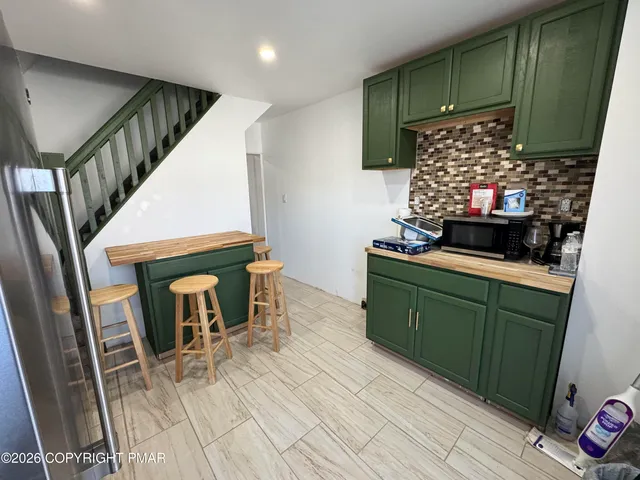 a kitchen with furniture and a fireplace
