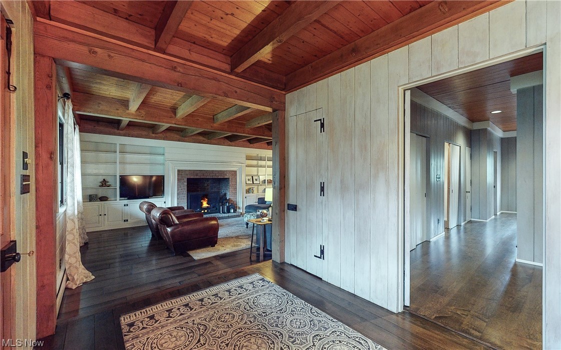 320 Ely Road Akron, OH 44313 - Photo 6 of 36 Living room featuring dark hardwood / wood-style floors, beam ceiling, a fireplace, and wooden ceiling