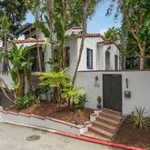 a view of a house with potted plants