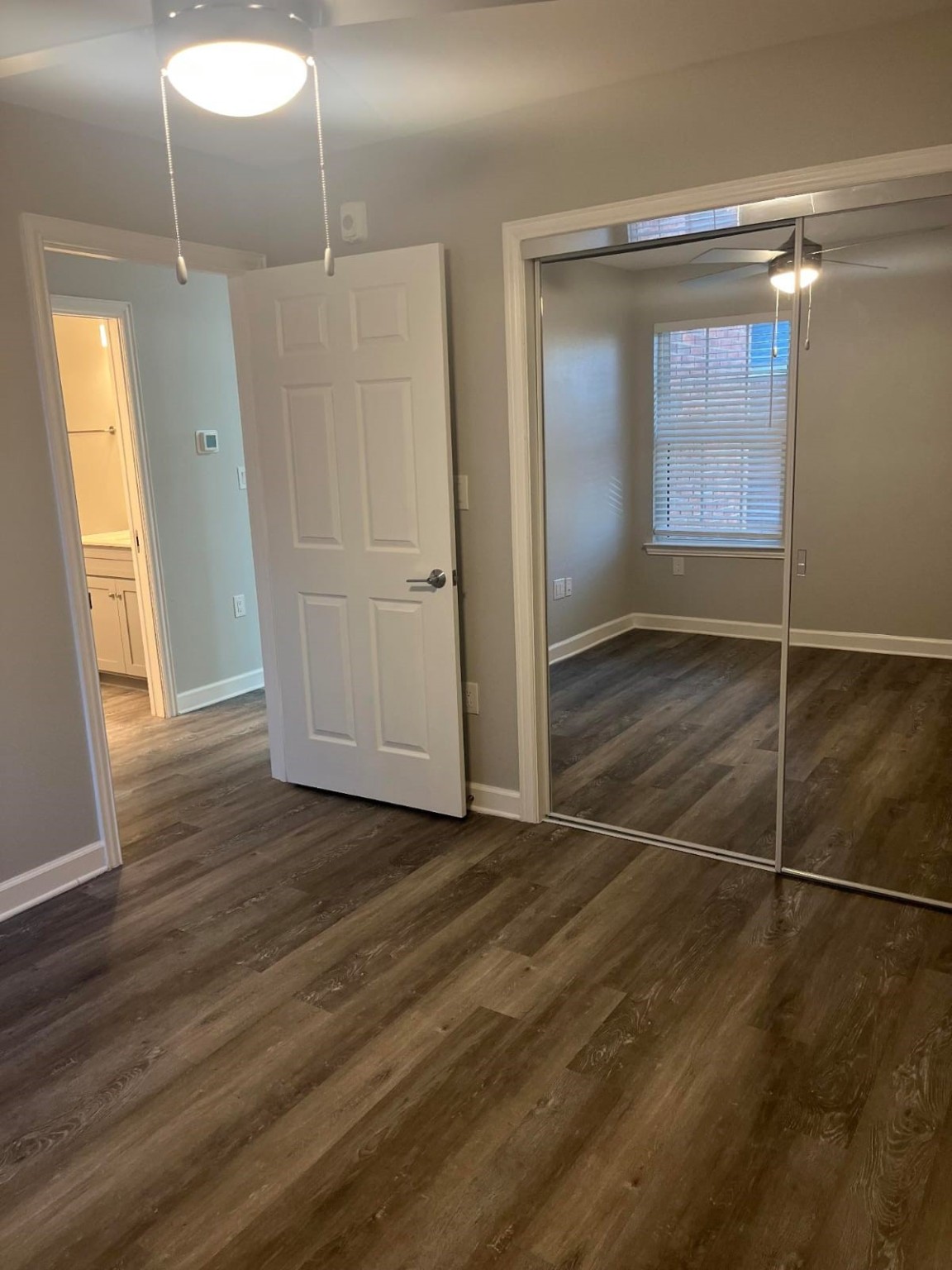 3737 Timberglen Road, Unit 2702 Dallas, TX 75287 - Photo 12 of 19 an empty room with wooden floor and windows