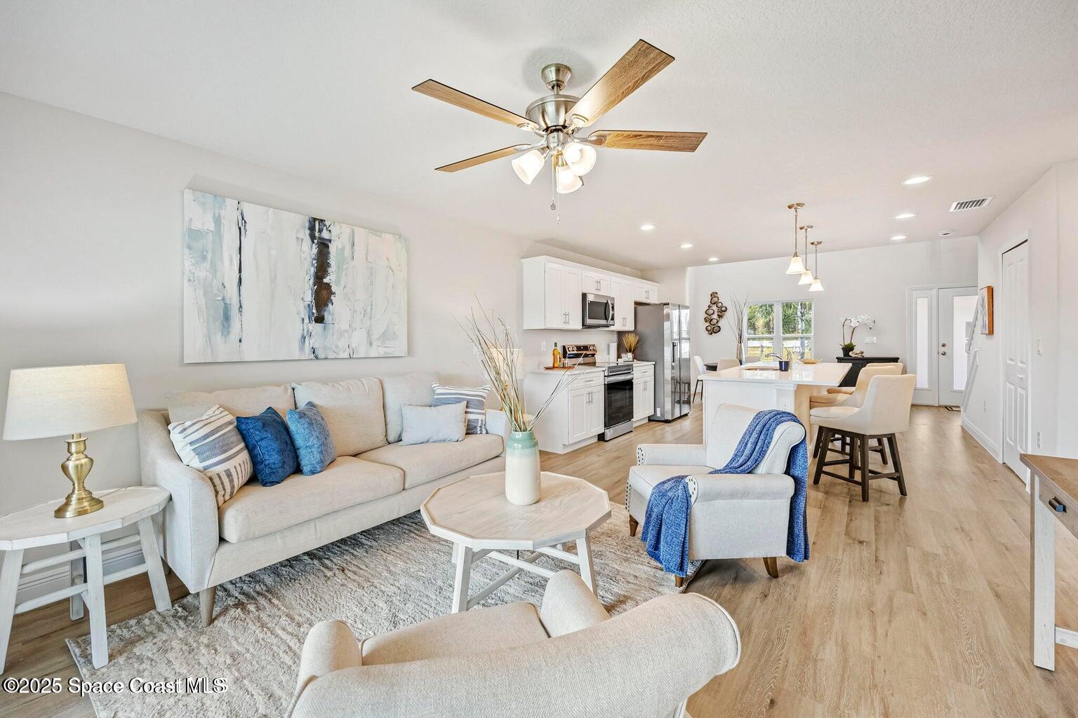 207 Hidden Woods Place Melbourne, FL 32901 - Photo 13 of 33 a living room with furniture kitchen view and a table