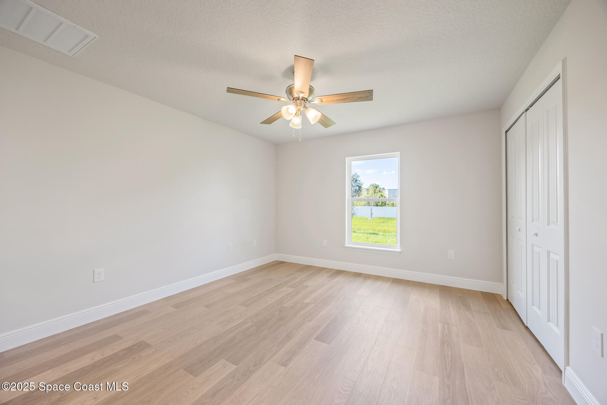 207 Hidden Woods Place Melbourne, FL 32901 - Photo 21 of 33 wooden floor in an empty room with a window