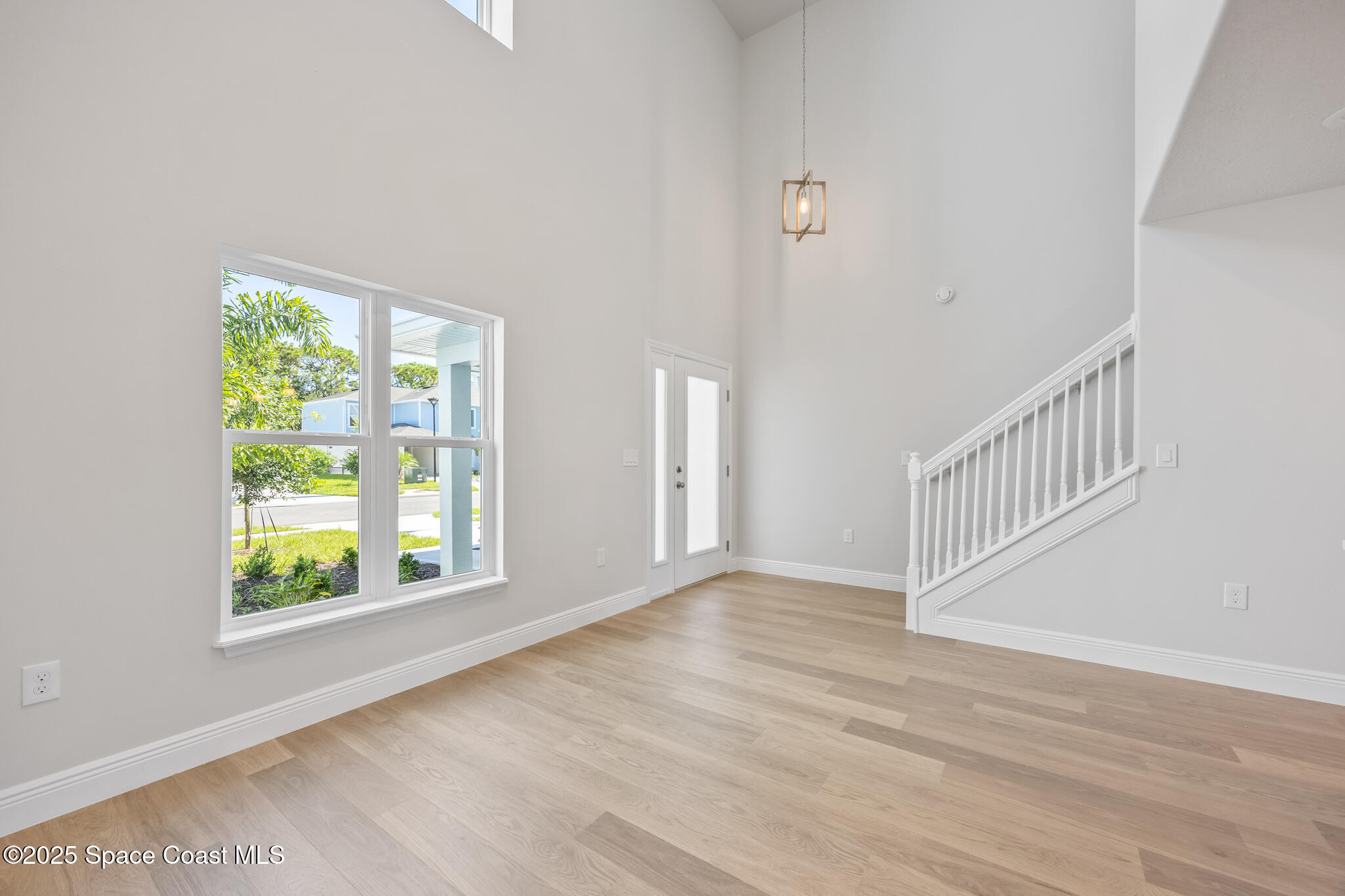 207 Hidden Woods Place Melbourne, FL 32901 - Photo 6 of 33 a view of an empty room with wooden floor and a window
