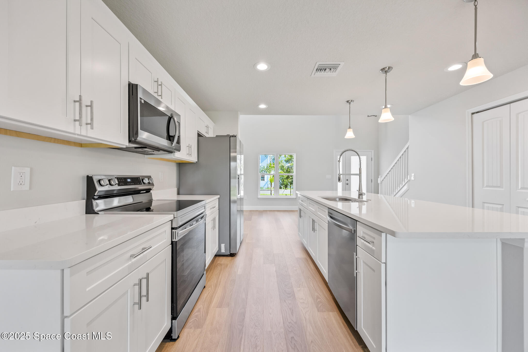 207 Hidden Woods Place Melbourne, FL 32901 - Photo 10 of 33 a large kitchen with stainless steel appliances lots of counter space sink and cabinets