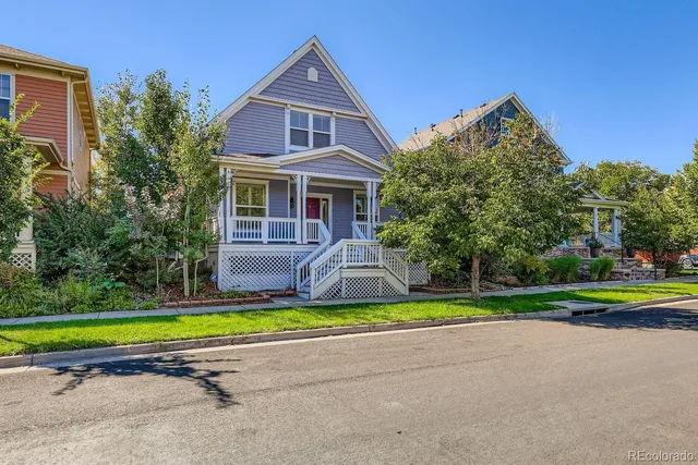a view of a house with a big yard and potted plants