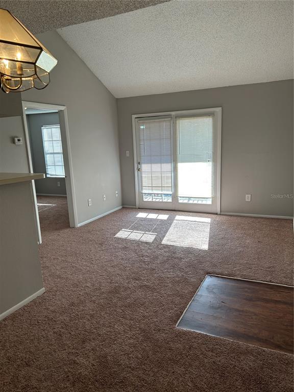 241 Afton Square, Unit 304 Altamonte Springs, FL 32714 - Photo 3 of 17 an empty room with floor to ceiling windows and fireplace