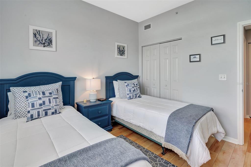 2090 Matecumbe Key Road, Unit 1207 Punta Gorda, FL 33955 - Photo 12 of 23 a bedroom with two beds and painting on the wall