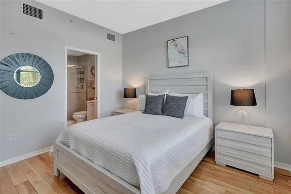 a bedroom with a bed and a chandelier