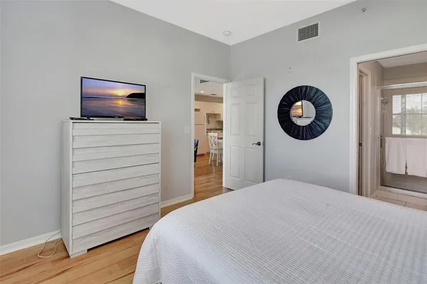 a bedroom with a bed and a flat screen tv