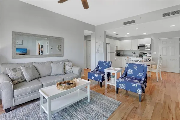 a living room with furniture and kitchen view