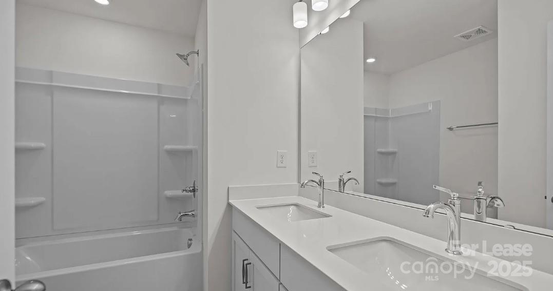 2035 Near Pt Road Charlotte, NC 28208 - Photo 13 of 13 a bathroom with a tub sink and mirror