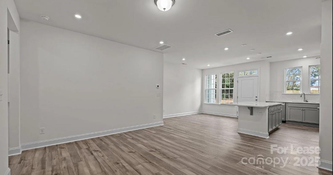 2035 Near Pt Road Charlotte, NC 28208 - Photo 6 of 13 a view of an empty room with window and wooden floor